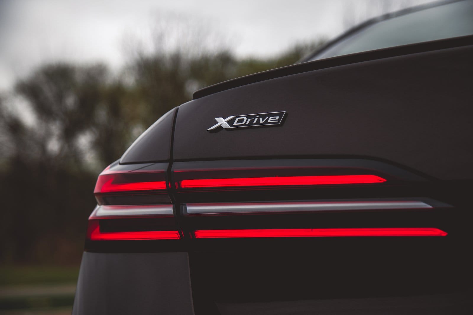 Close-up of BMW 550e xDrive electric vehicle rear with xDrive badge and taillight design