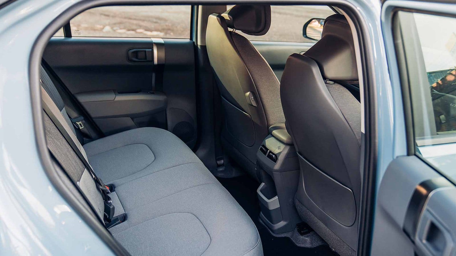 Interior view of Kia EV3 electric vehicle rear seats with fabric upholstery