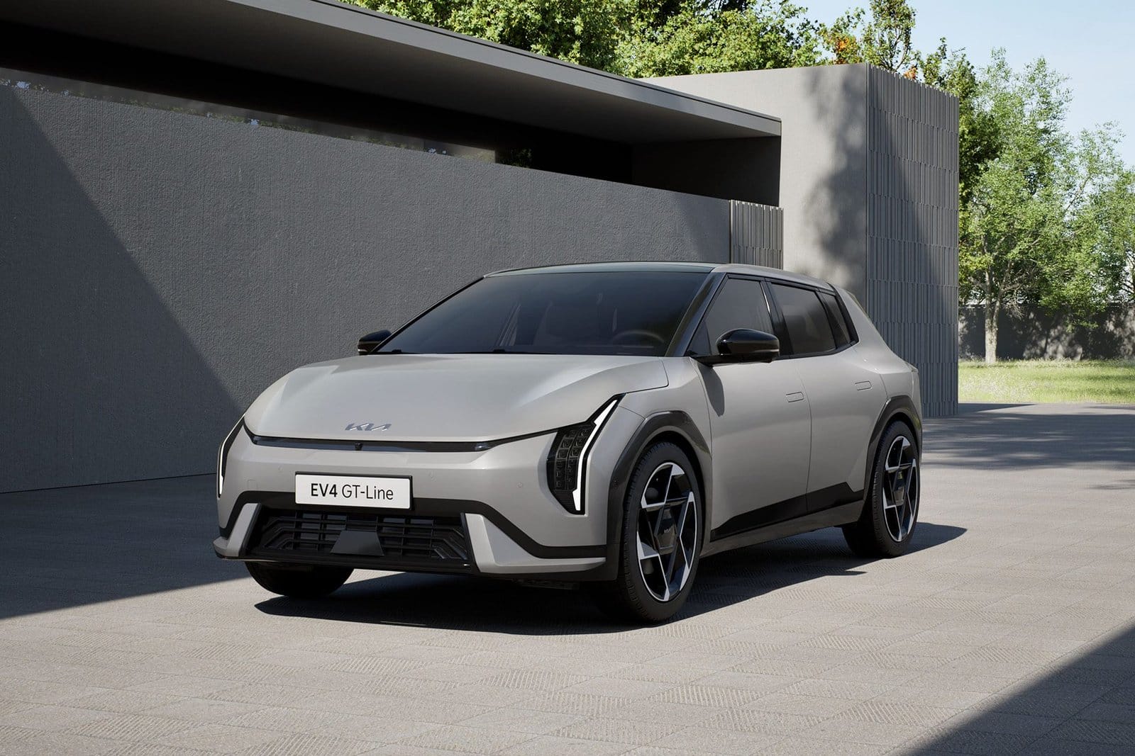 Front view of Kia EV4 electric vehicle GT-Line hatchback parked in a modern residential driveway