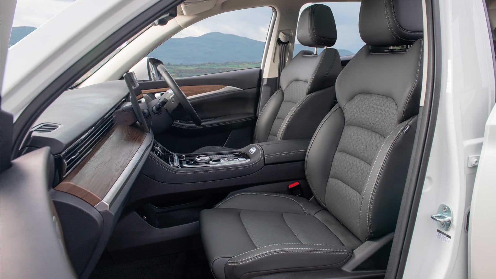 Front seats and dashboard of the Skywell BE11 electric vehicle, Chinese EV, showing upholstery design and cabin arrangement.
