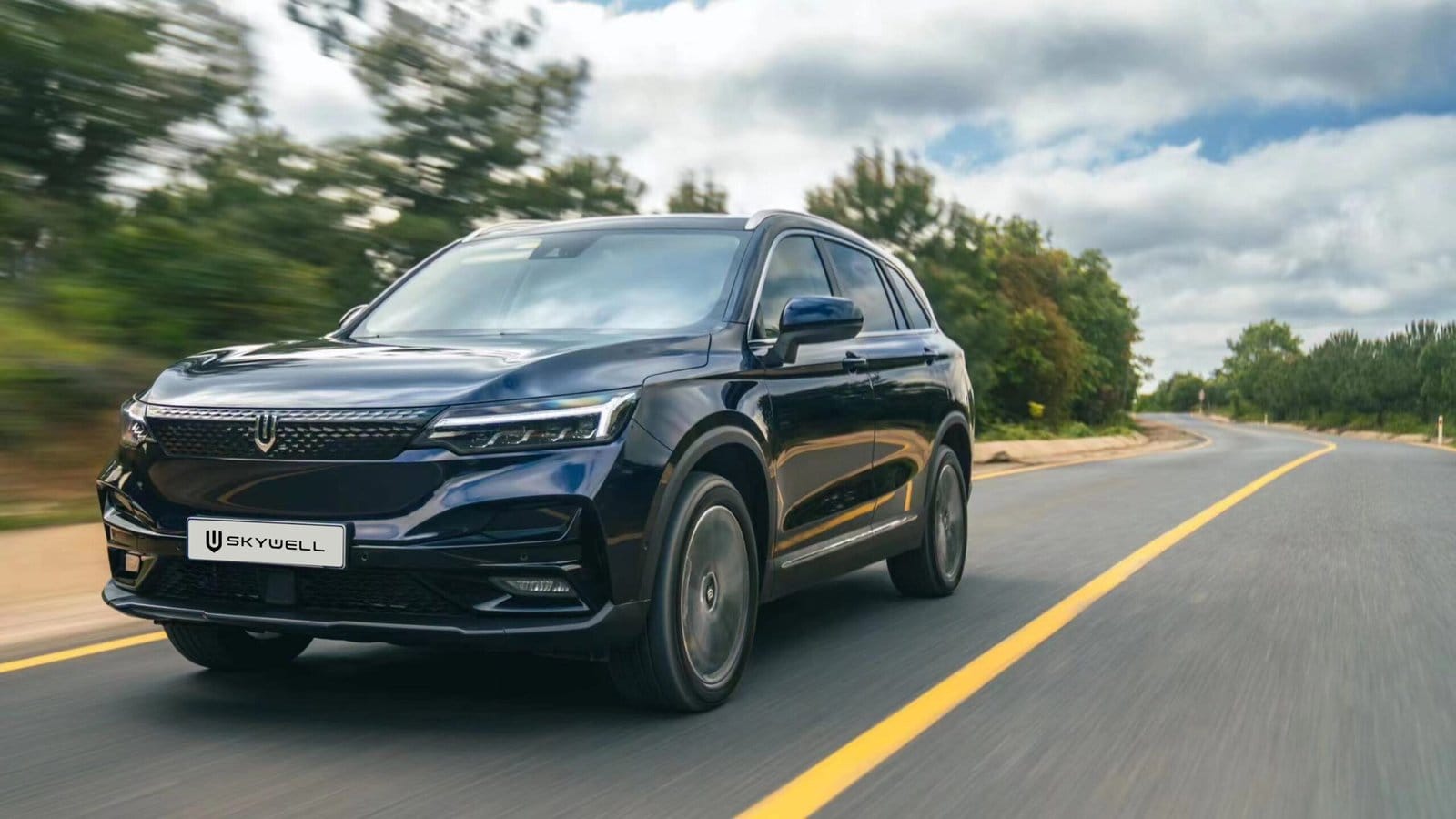 Front view of a Skywell BE11 electric vehicle, Chinese EV driving on a curved road