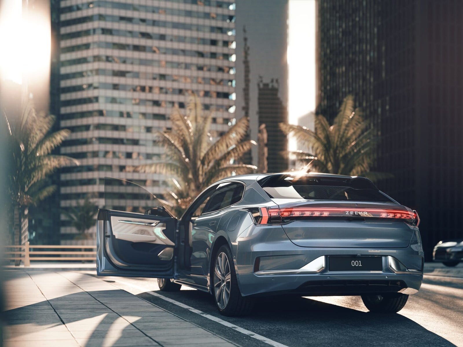 Rear-side view of a ZEEKR 001 electric vehicle, Chinese EV, parked in a city area with an open door and tall buildings in the background.